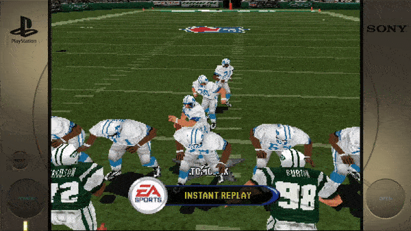 **On the screen:** - EA SPORTS - INSTANT REPLAY **On the field:** - TOMLINSON - ABRAMS - SMITH